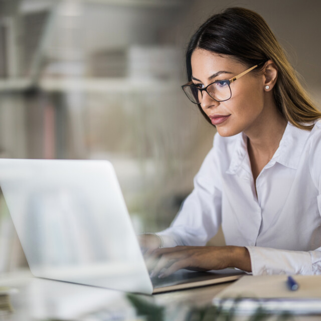 Young Businesswoman Typing An E Mail On Laptop At Home Office.